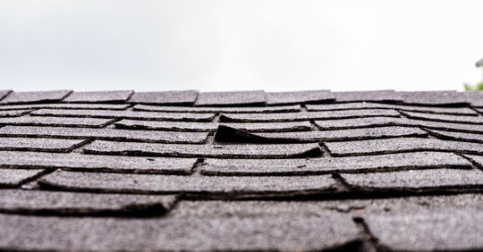 Close-up on damaged asphalt shingles