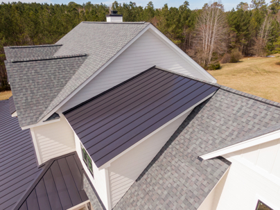 house with asphalt shingles and metal accent