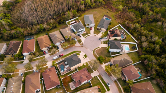aerial view of cul de sac homes beside woodland